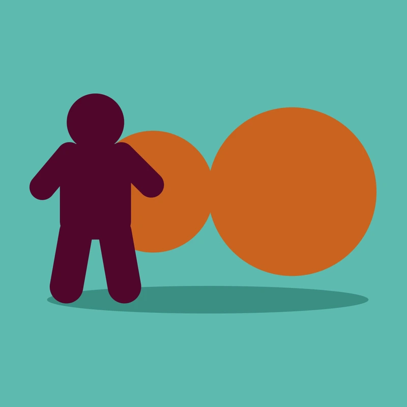 A lone dark figure standing in front of two orange circles, one small and one large, on a teal background