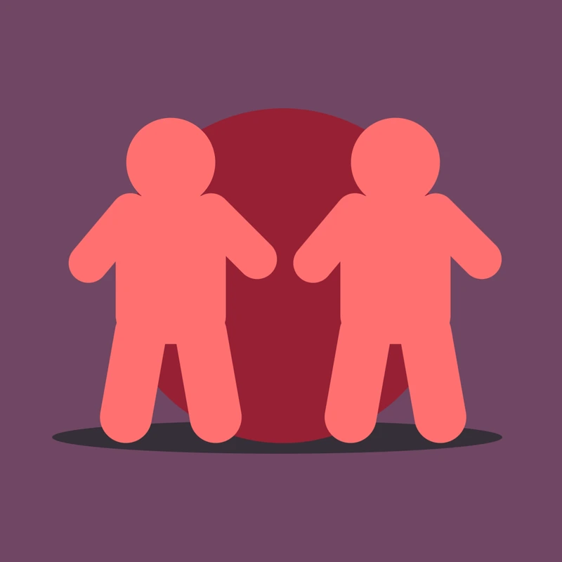 Two matching figures standing side by side in front of a soft circle
